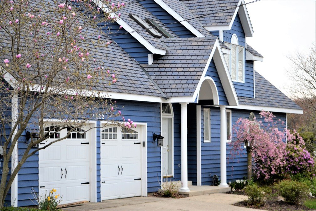 blue-sided home with double garage door styles