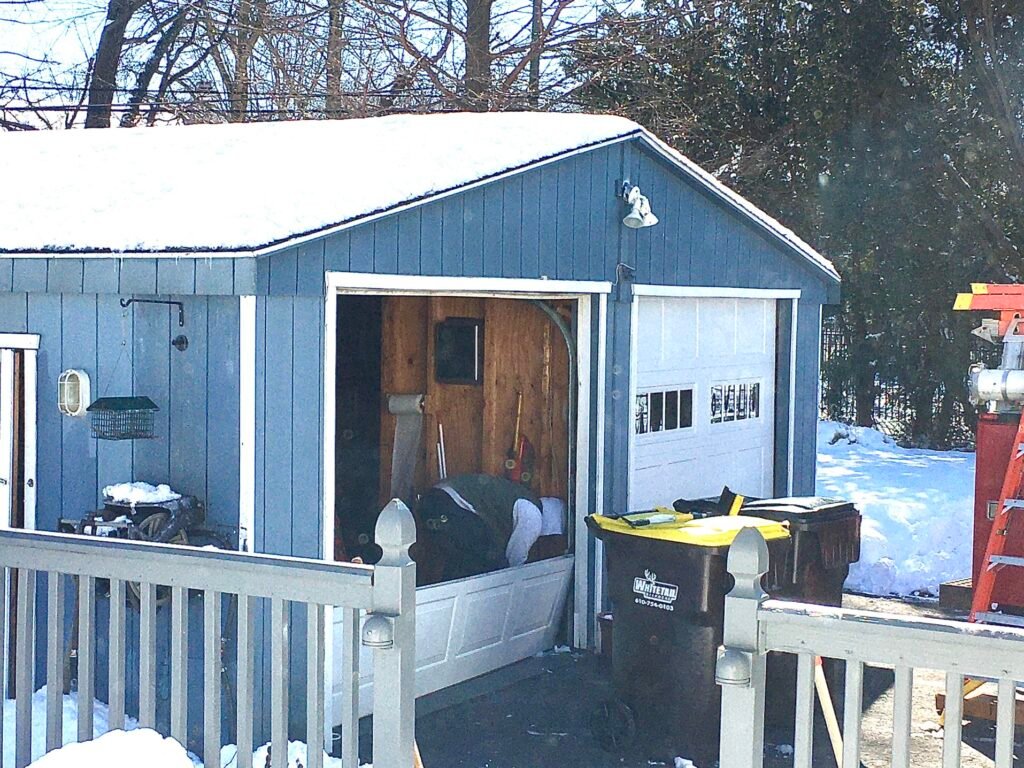 man replacing his garage doors